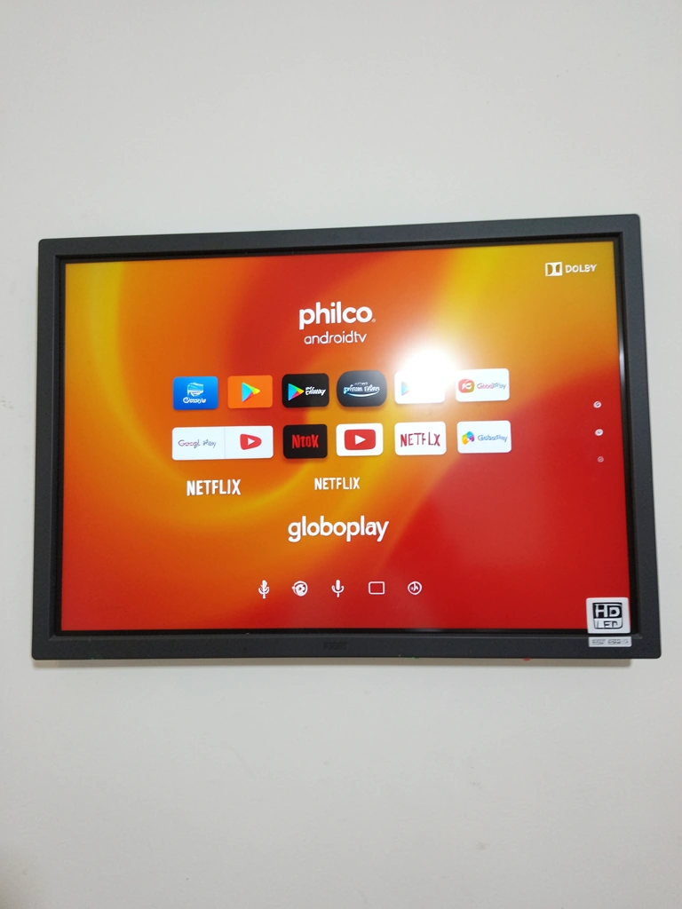 Tela de TV exibindo a interface do Android TV com ícones de aplicativos